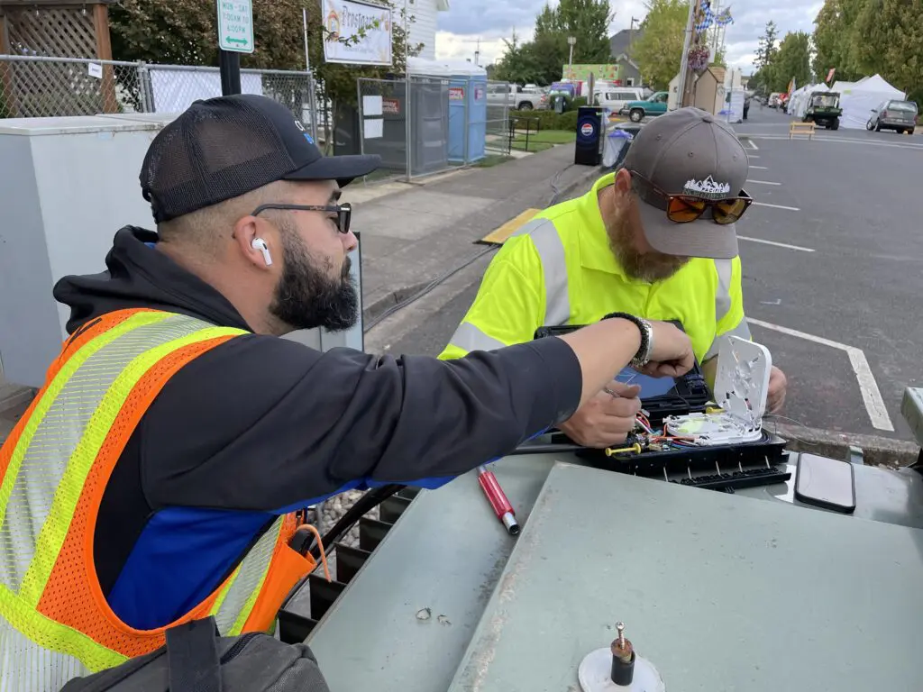 Comcast technicians work at Oktoberfest.