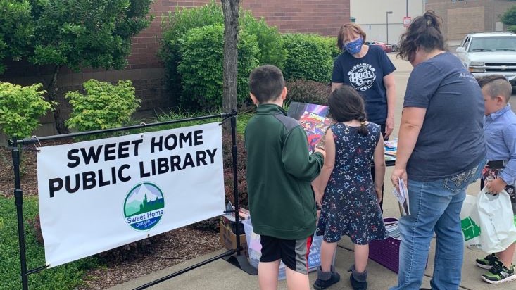 People gather in front of their local public library