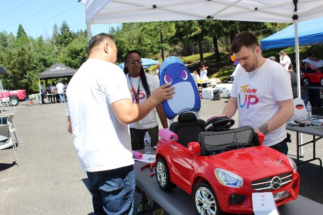 Comcast team members install a kickboard for extra support in the cars.