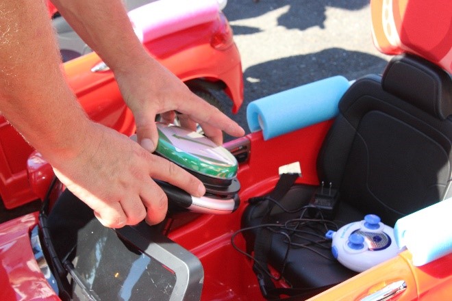 Comcast team members add stop-and-go buttons to the cars.