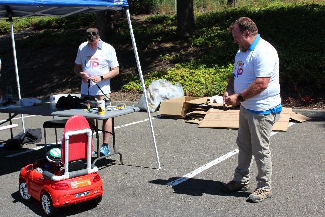 Comcast team members test out the cars before the kids pick them up.