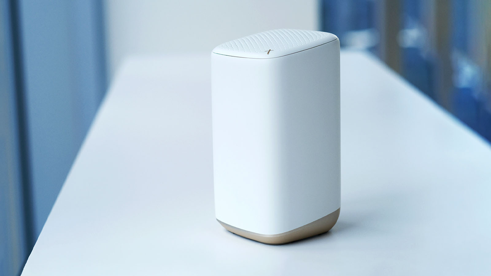 A white router rests on a table.