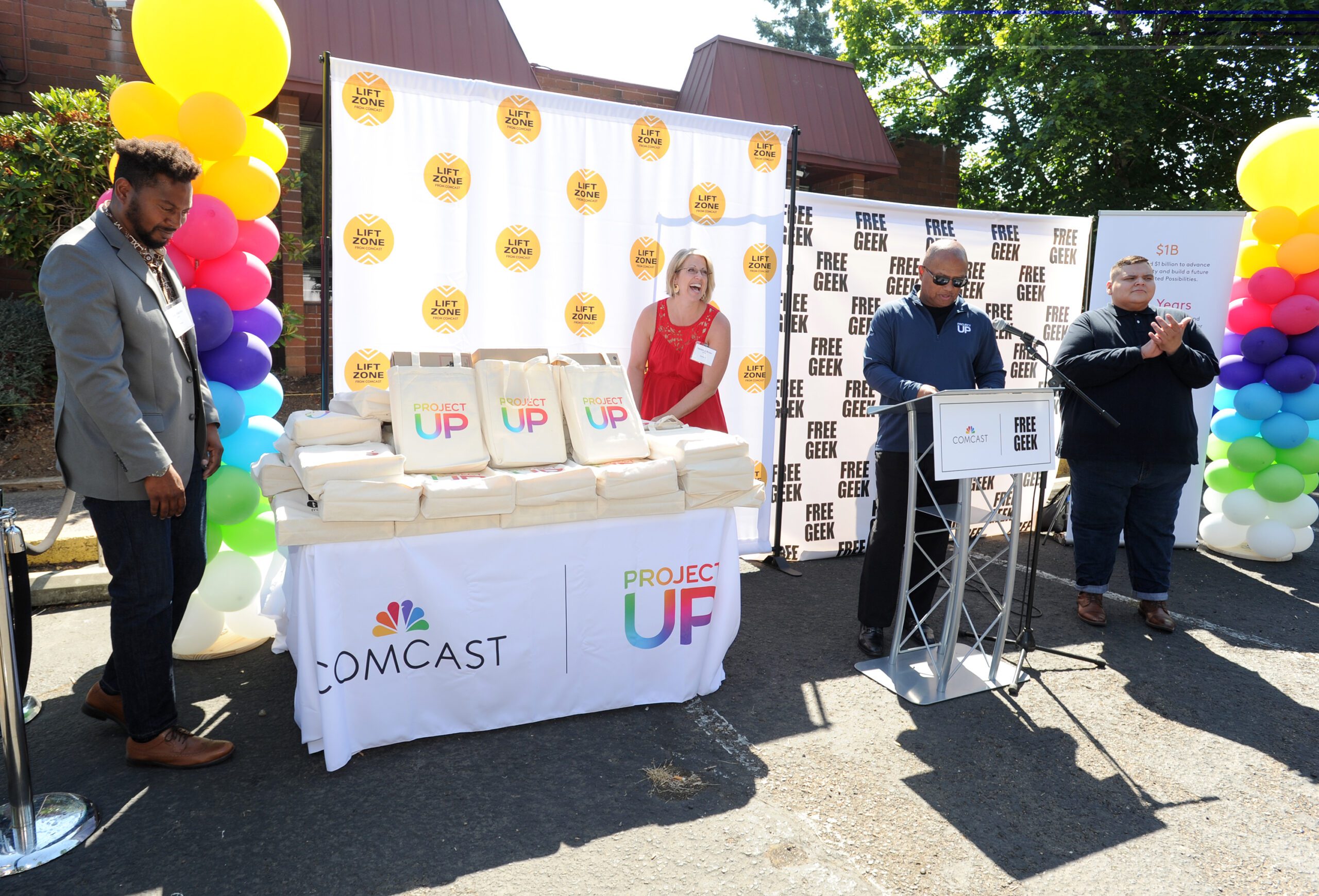 Comcast reps present laptops in bags. 