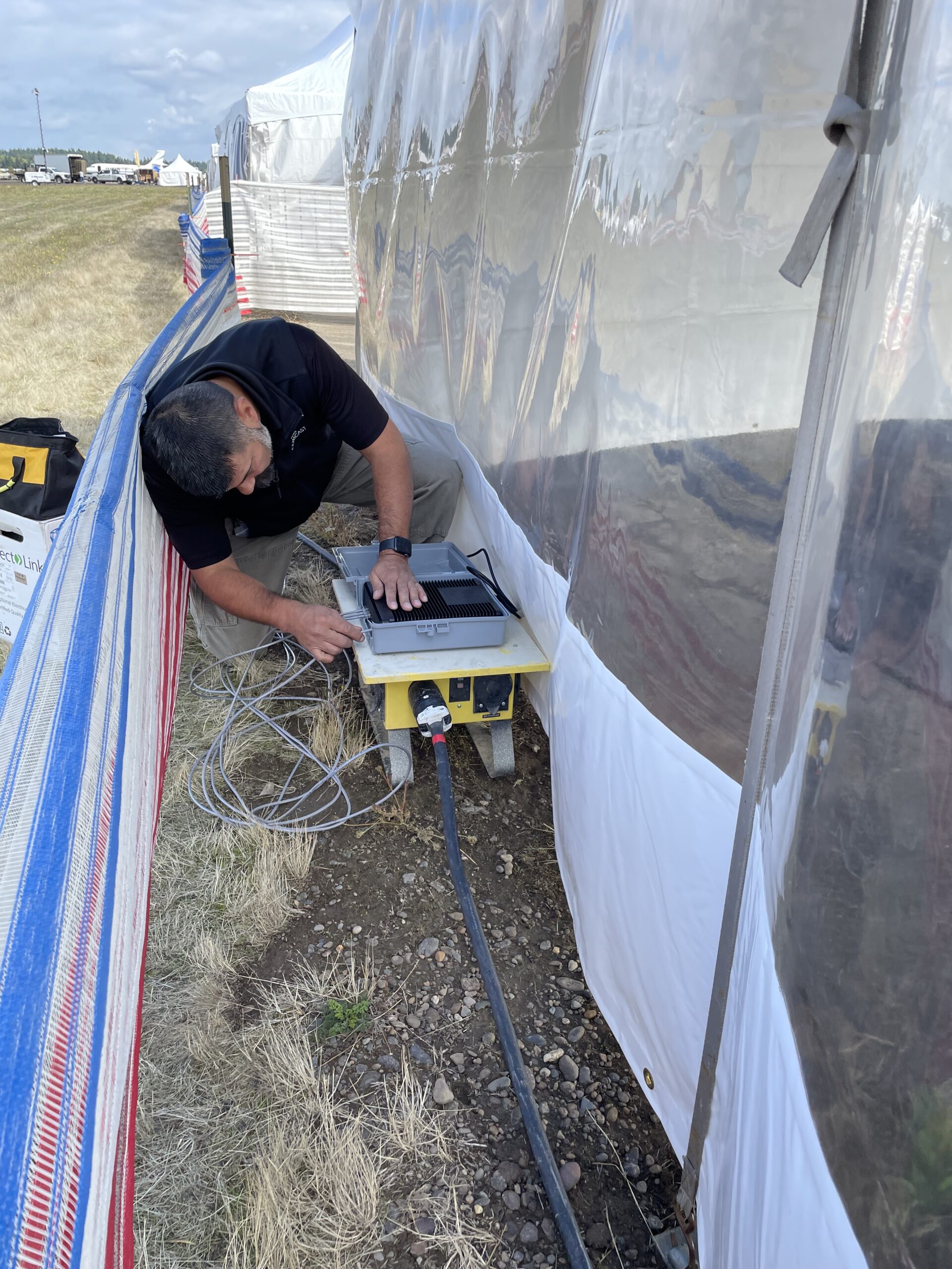 Comcast technicians work on cable at the Air Show.