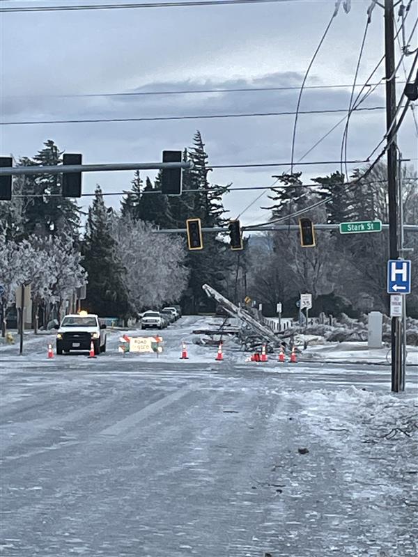 Xfinity vans and trucks working at an icy intersection.